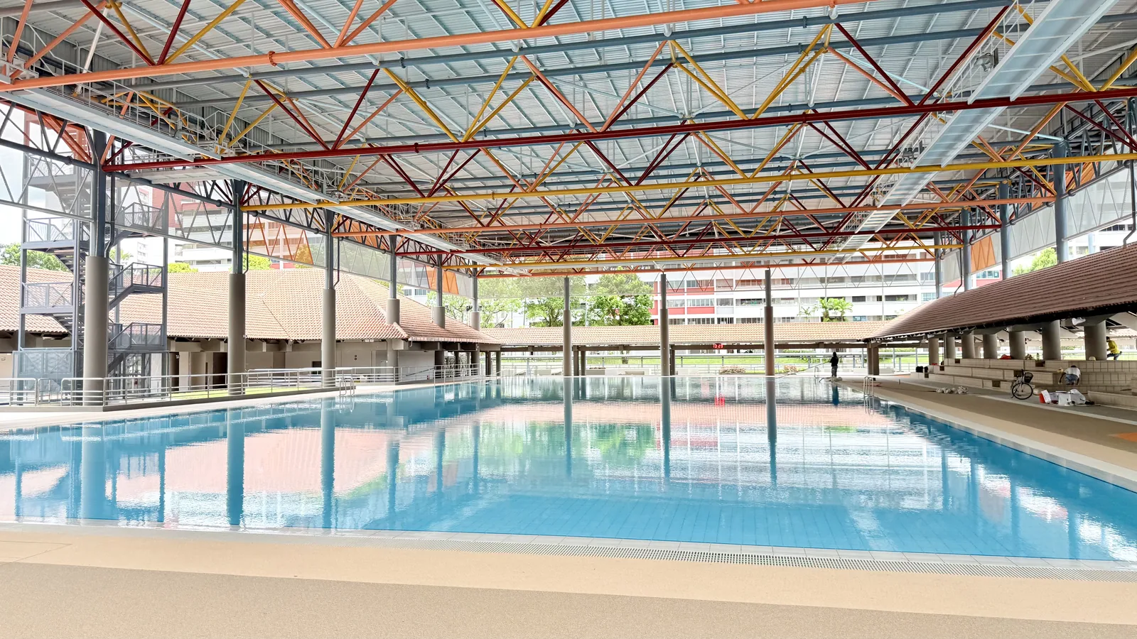 Covered sheltered teaching pool under the steel-truss roof at Hougang Swimming Complex
